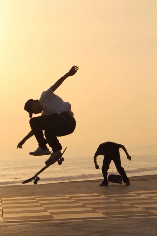 Skateboarders at sunset